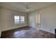 Empty bedroom featuring hardwood floors, white trim, and a window providing natural light at 2228 Emory St, Covington, GA 30014