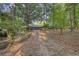 View of wooded lot and driveway leading to house, creating a private, secluded entrance at 2228 Emory St, Covington, GA 30014