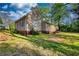 Exterior angle showcasing backyard with ample yard space surrounded by lush trees at 2228 Emory St, Covington, GA 30014
