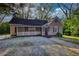 Charming single-story home with a screened-in porch and gravel landscaping at 2228 Emory St, Covington, GA 30014