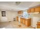 An older kitchen featuring wood cabinets, linoleum flooring and a window for natural light at 2228 Emory St, Covington, GA 30014