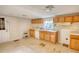 An older kitchen featuring wood cabinets, linoleum flooring and a window for natural light at 2228 Emory St, Covington, GA 30014