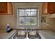 Close up of a kitchen sink with a window, wood cabinets and minimal counter space at 2228 Emory St, Covington, GA 30014