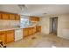An older kitchen featuring wood cabinets, linoleum flooring and a window for natural light at 2228 Emory St, Covington, GA 30014