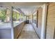Covered porch overlooking lush yard with mature trees, offering an outdoor living space at 2228 Emory St, Covington, GA 30014