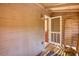 Porch featuring whitewashed wood paneling, open screened door, and vintage light fixture at 2228 Emory St, Covington, GA 30014