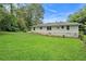 Spacious backyard features a well-maintained lawn and the home's exterior with painted white brick at 2406 Tilson Rd, Decatur, GA 30032