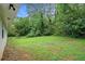 A sprawling backyard with lush greenery, providing ample space for outdoor activities and relaxation at 2406 Tilson Rd, Decatur, GA 30032