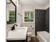 Bathroom with modern vanity, white fixtures, and dark gray tiled shower at 2406 Tilson Rd, Decatur, GA 30032