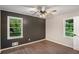 Bedroom with accent wall, and two windows with green leafy scenery outdoors at 2406 Tilson Rd, Decatur, GA 30032