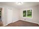 Bright bedroom with wood-look floors, double door closet, and a window offering natural light at 2406 Tilson Rd, Decatur, GA 30032