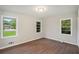Neutral bedroom featuring three windows, wood floors, and ample natural light at 2406 Tilson Rd, Decatur, GA 30032