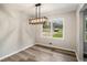 Dining room with wooden floor, natural light and a modern style light fixture at 2406 Tilson Rd, Decatur, GA 30032