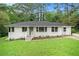 Well-maintained single-story home with a large front yard, white painted brick and inviting entryway at 2406 Tilson Rd, Decatur, GA 30032