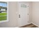 Close-up of the front door showcasing detailed glass panes, alongside a window providing natural light to the home's interior at 2406 Tilson Rd, Decatur, GA 30032