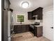 Well-lit kitchen with stainless steel appliances and dark brown cabinets at 2406 Tilson Rd, Decatur, GA 30032