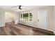Inviting living room showcasing hardwood floors, a decorative ceiling fan, and ample natural light from the windows at 2406 Tilson Rd, Decatur, GA 30032