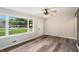 Bright living room featuring wood flooring, a ceiling fan, and large picture windows letting in natural light at 2406 Tilson Rd, Decatur, GA 30032