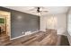 Living room featuring hardwood floors, dark accent wall, and adjoining dining room at 2406 Tilson Rd, Decatur, GA 30032
