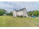 Spacious backyard featuring a well-maintained lawn and a traditional two-story home at 4023 Port Springs Trl, Snellville, GA 30039