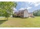 Exterior view highlighting the home's architecture and expansive, green backyard at 4023 Port Springs Trl, Snellville, GA 30039