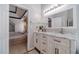 Bright bathroom with marble countertops, white cabinets, and a glimpse into the bedroom at 4023 Port Springs Trl, Snellville, GA 30039