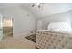 Bedroom with vaulted ceilings features neutral walls, plush carpeting, and a large decorative headboard at 4023 Port Springs Trl, Snellville, GA 30039