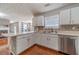 Renovated kitchen with white cabinets, mosaic backsplash, and stainless steel appliances at 4023 Port Springs Trl, Snellville, GA 30039