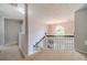 Bright upstairs landing featuring carpet, white railings, and natural light at 4023 Port Springs Trl, Snellville, GA 30039