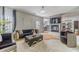 Living room with modern sofas, stylish decor, and an open flow to the kitchen area at 4023 Port Springs Trl, Snellville, GA 30039