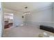 Open-concept living space with plush carpeting and a modern light fixture, showcasing ample room at 4023 Port Springs Trl, Snellville, GA 30039