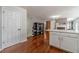 Bright living room featuring hardwood floors, display shelves, and white kitchen island at 4023 Port Springs Trl, Snellville, GA 30039