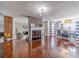 Spacious living room featuring a fireplace and open dining area with hardwood flooring at 4023 Port Springs Trl, Snellville, GA 30039