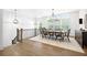 Elegant dining room with hardwood floors, modern lighting, and large windows at 6807 Prelude Dr, Atlanta, GA 30328