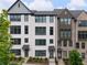 Beautiful townhouse with painted brick, dark windows, and mature landscaping at 6807 Prelude Dr, Atlanta, GA 30328