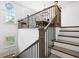 Bright, modern staircase with iron spindles leading to second-floor dining area at 6807 Prelude Dr, Atlanta, GA 30328