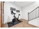 Workout room near stairs with hardwood floors and encouraging wall art at 6807 Prelude Dr, Atlanta, GA 30328