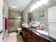 Bathroom with granite double vanity, modern fixtures, and tile shower at 6980 Roswell Road # A8, Atlanta, GA 30328