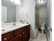Well-lit bathroom with a single sink vanity, modern fixtures, and walk-in shower at 6980 Roswell Road # A8, Atlanta, GA 30328