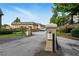 Gated community entrance with landscaped grounds, mature trees, and on-site parking at 6980 Roswell Road # A8, Atlanta, GA 30328