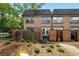 Charming brick townhouse with a fenced front yard and manicured landscaping at 6980 Roswell Road # A8, Atlanta, GA 30328