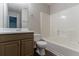 Functional bathroom with a combination tub/shower and vanity with wood-tone cabinets, providing essential amenities at 12241 Cypress Way, Fayetteville, GA 30215