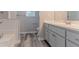 Bright bathroom with modern vanity, fixtures, and tiled tub surround, offering a clean aesthetic at 12241 Cypress Way, Fayetteville, GA 30215