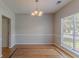 Dining room with hardwood floors and traditional chandelier at 12241 Cypress Way, Fayetteville, GA 30215