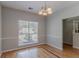 Dining room featuring hardwood floors, wainscoting, and large window at 12241 Cypress Way, Fayetteville, GA 30215