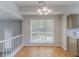 Dining area with hardwood floors, a modern chandelier, and a large window at 12241 Cypress Way, Fayetteville, GA 30215