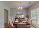 Staged dining room with hardwood floors, traditional chandelier, and table setting at 12241 Cypress Way, Fayetteville, GA 30215