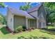 Well-maintained home exterior featuring neutral siding, lush lawn, and manicured landscaping at 12241 Cypress Way, Fayetteville, GA 30215