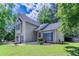Inviting front of a two-story home with manicured lawn, dark shutters, and a lovely front door at 12241 Cypress Way, Fayetteville, GA 30215