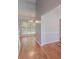 Hallway with gleaming hardwood floors and natural light from the window at 12241 Cypress Way, Fayetteville, GA 30215